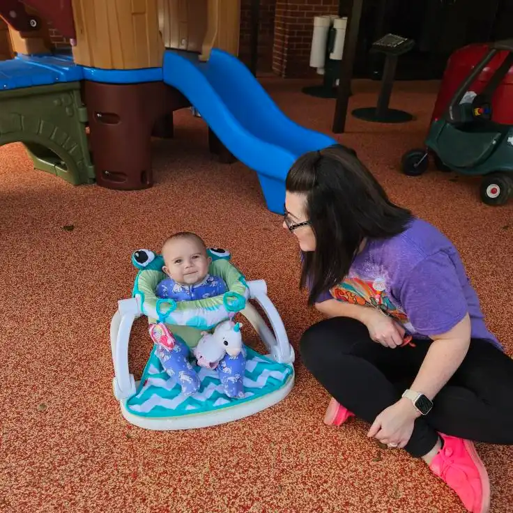 infant child sitting in a bounce chair