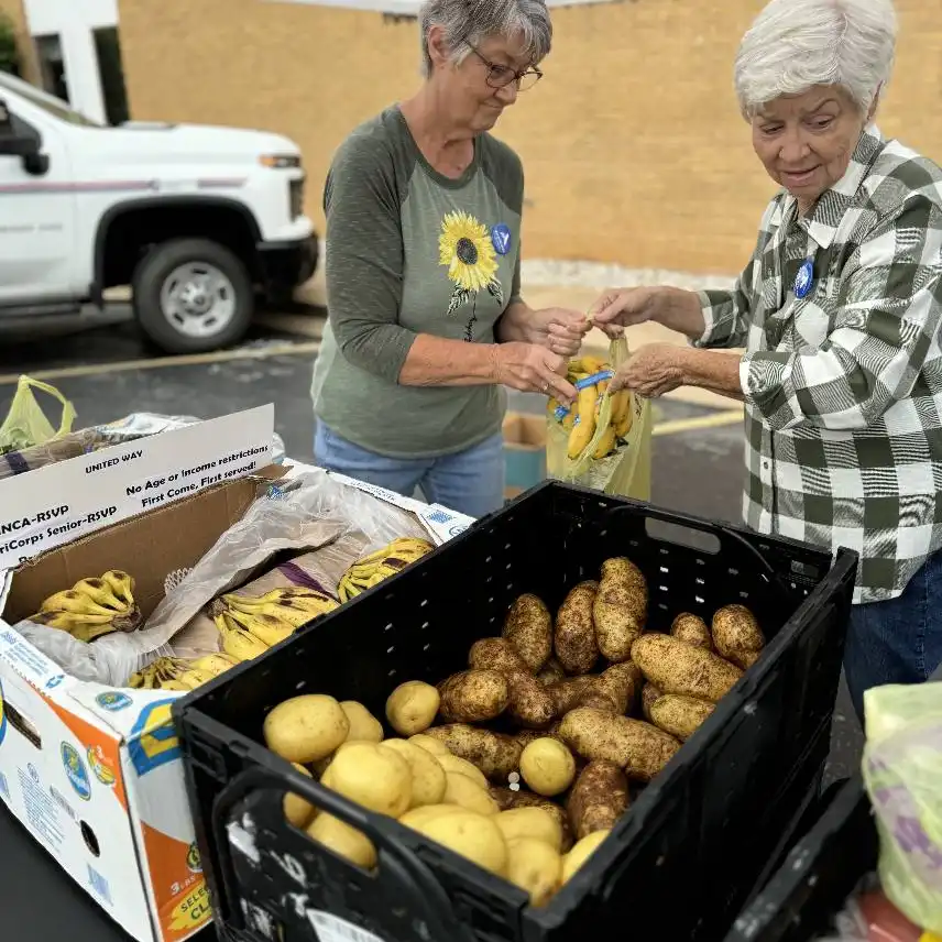 INCA volunteers distributing boxes of food