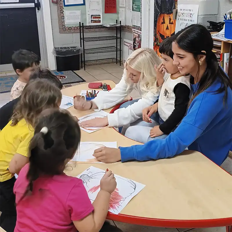 children drawing with crayons at a head start program