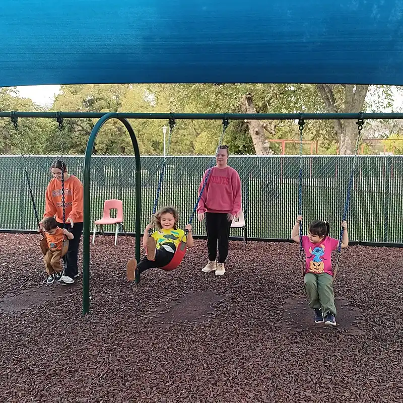 children on swings at a head start program