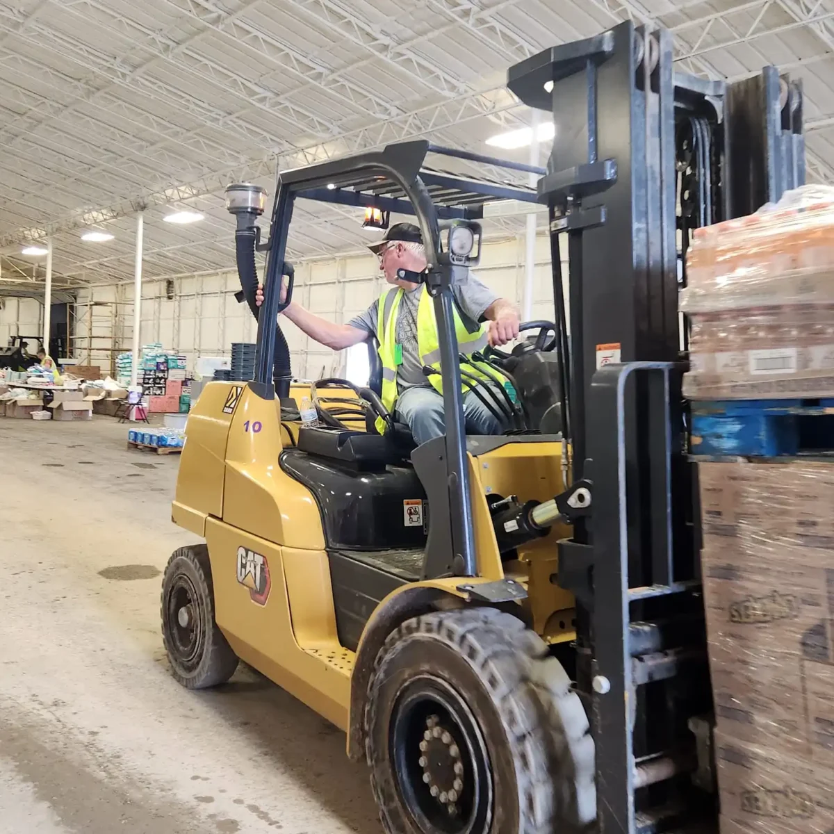 Man driving a skid loader for Americorps RSVP Oklahoma