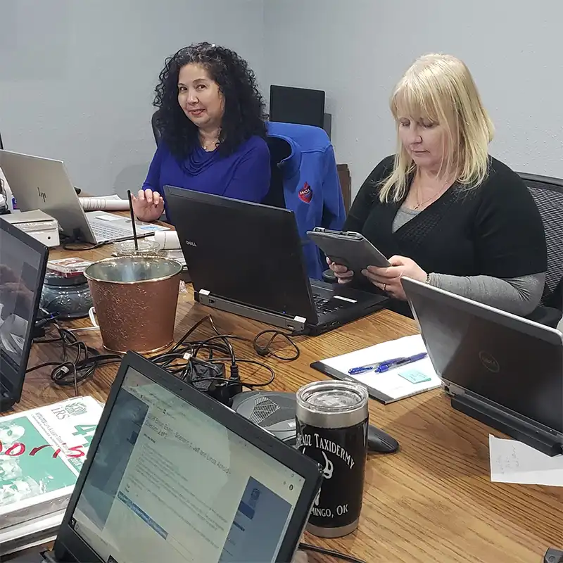 VITA tax preparers working at laptops