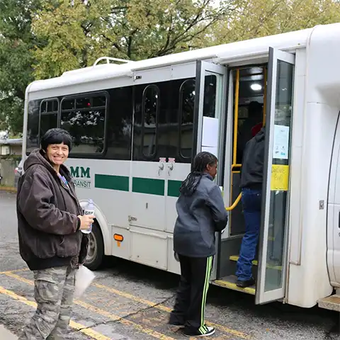 Passengers waiting to enter a JAMM transit bus