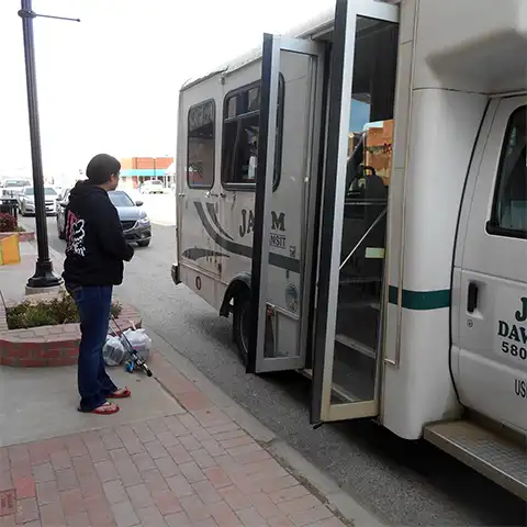 Passenger waiting to enter a JAMM Transit bus