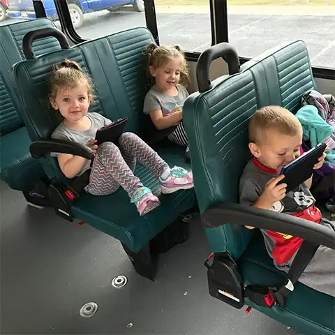 children riding a JAMM transit bus