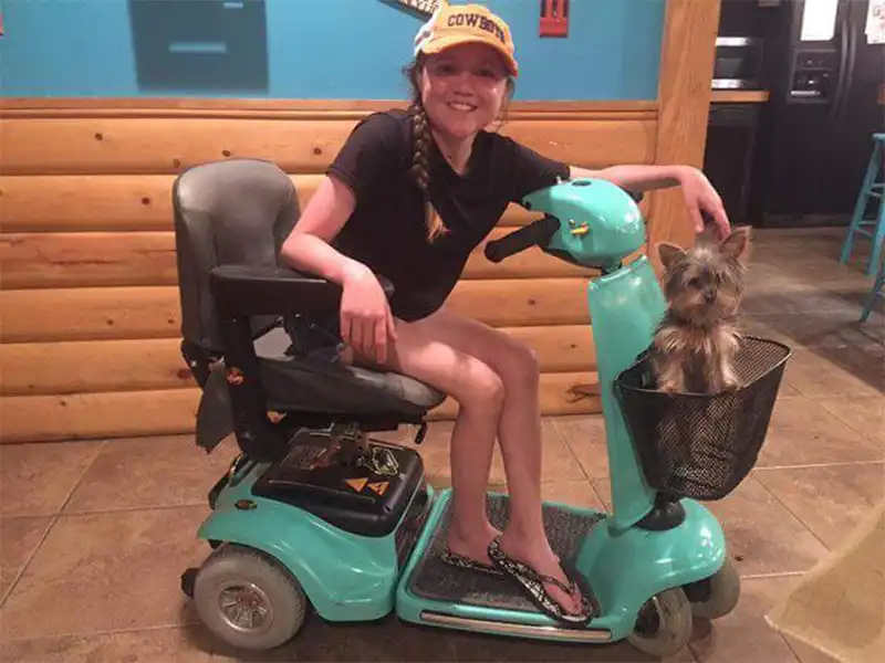 A woman riding a mobility scooter