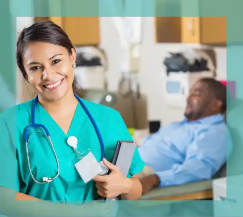 A nurse wearing green scrubs in a hospital room