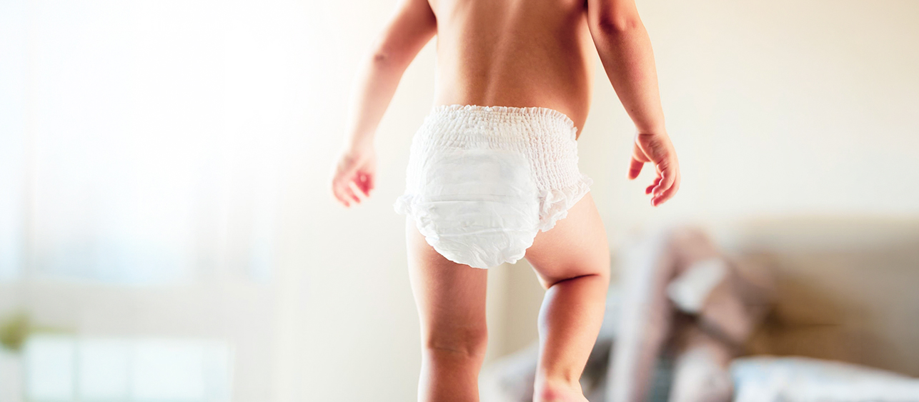baby walking wearing diapers
