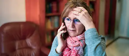 elderly woman speaking on the phone about medicare fraud